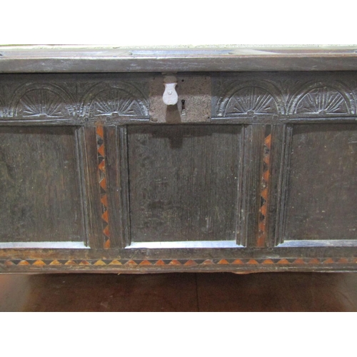 1370 - 18th century oak panelled coffer with carved frieze and geometric dog tooth inlay, 116cm long