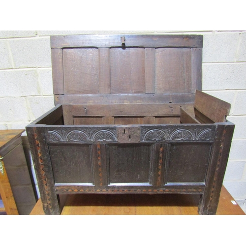 1370 - 18th century oak panelled coffer with carved frieze and geometric dog tooth inlay, 116cm long