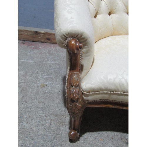 1384 - Victorian walnut chaise longue with carved and shaped outline and button back, raised on cabriole su... 