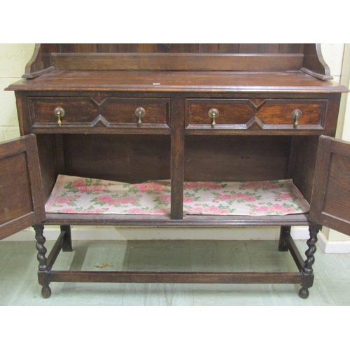 1395 - Edwardian oak cottage dresser and rack, the base enclosed by a pair of panelled drawers and two frie... 