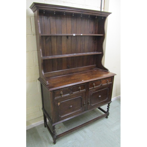 1395 - Edwardian oak cottage dresser and rack, the base enclosed by a pair of panelled drawers and two frie... 