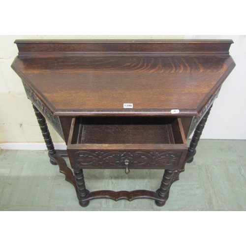 1396 - Edwardian oak side table in a Jacobean style, with canted corners enclosing a frieze drawer on bobbi... 