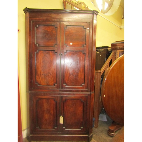 1534 - A large 19th century mahogany corner cupboard enclosed by two pairs of panelled doors with well matc... 