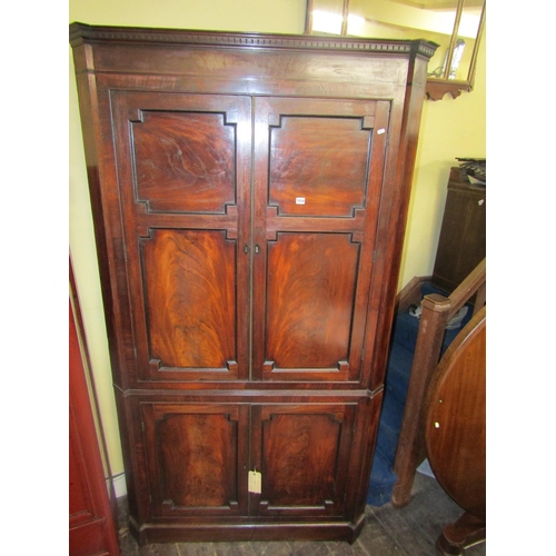 1534 - A large 19th century mahogany corner cupboard enclosed by two pairs of panelled doors with well matc... 