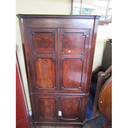 1534 - A large 19th century mahogany corner cupboard enclosed by two pairs of panelled doors with well matc... 