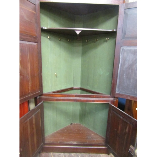 1534 - A large 19th century mahogany corner cupboard enclosed by two pairs of panelled doors with well matc... 