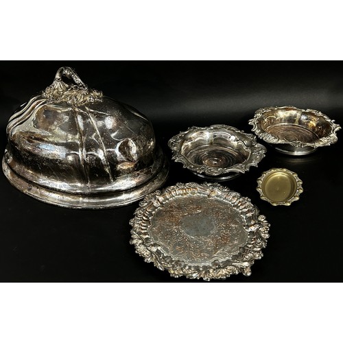 222 - A silver plated domed meat cover, a pair wine bottle coaster, a silver plated tray and a small dish.