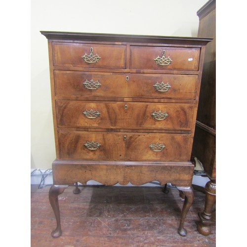 1498 - A Georgian walnut chest on stand, the chest of three long and two short drawers, the stand with shap... 