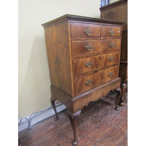 1498 - A Georgian walnut chest on stand, the chest of three long and two short drawers, the stand with shap... 