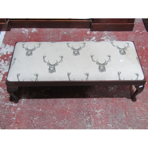 1366 - A foot stool with repeating stag pattern upholstered top raised on cabriole supports 100cm long