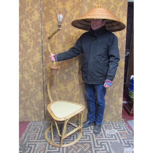 1060 - A vintage bound cane work low table and combined lamp with raised shaped neck supporting a tilted wi... 