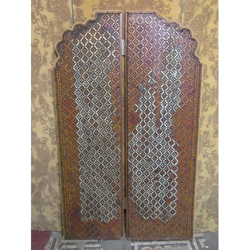 1311 - An overlaid two fold floorstanding wooden screen with arched outline and repeating floral lattice pa... 