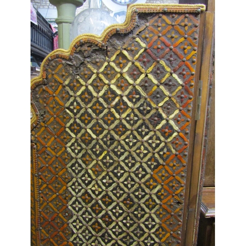 1311 - An overlaid two fold floorstanding wooden screen with arched outline and repeating floral lattice pa... 