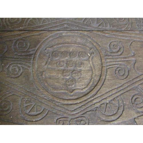 1341 - An antique oak demi-lune carved table with repeating geometric detail, armorial crests, and dated 16... 