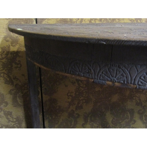 1341 - An antique oak demi-lune carved table with repeating geometric detail, armorial crests, and dated 16... 