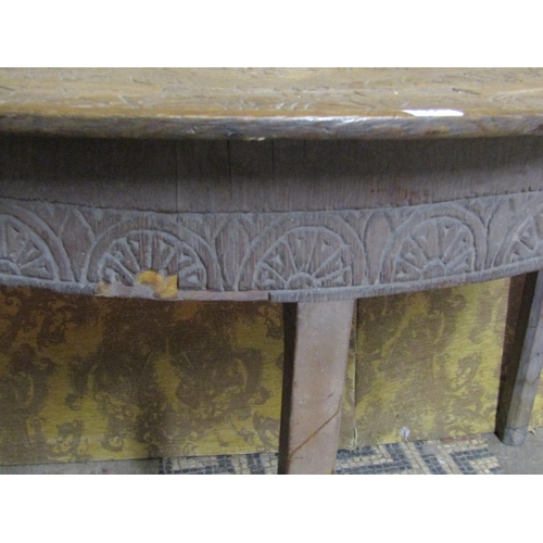 1341 - An antique oak demi-lune carved table with repeating geometric detail, armorial crests, and dated 16... 