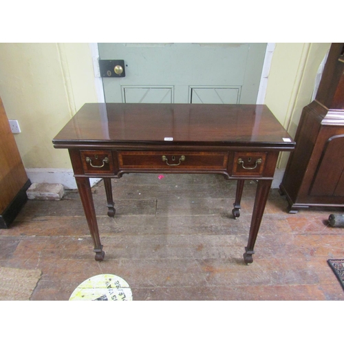 1509 - A George III mahogany fold over top tea table, the frieze fitted unusually with three frieze drawers... 