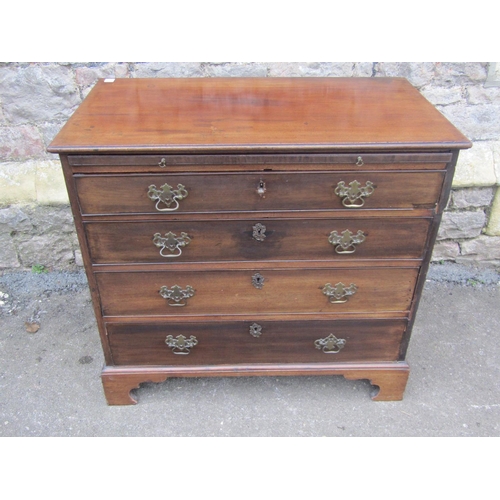 1520 - A George III mahogany chest of four long drawers with brush slide, brass fittings and raised on brac... 