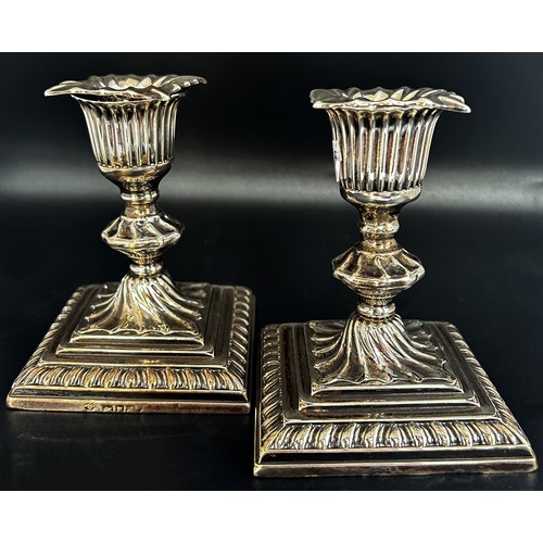 278 - A small pair of 19th century silver candlesticks with removable sconces raised on square stepped bas... 