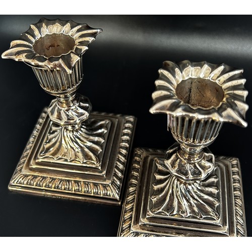 278 - A small pair of 19th century silver candlesticks with removable sconces raised on square stepped bas... 