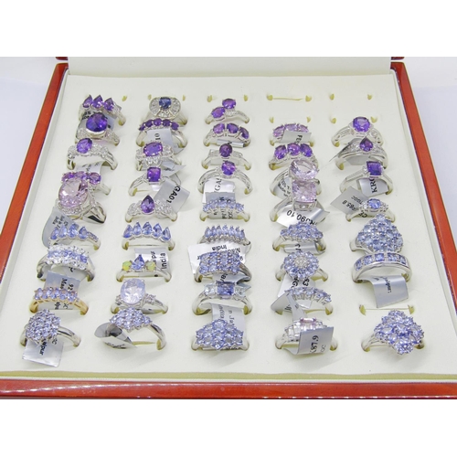 428 - Collection of purple - violet gem set silver dress rings, to include amethyst, tanzanite, opal, quar... 