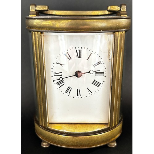 510 - Brass carriage clock with oval shaped case and eight day time piece