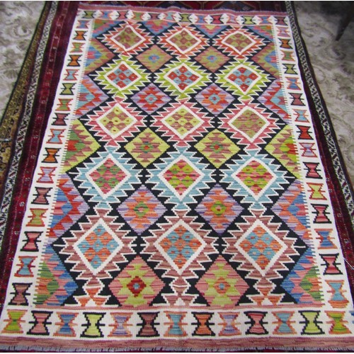 1565 - Chobi kilim,  with an all over geometric  stepped medallion pattern in pale hues, 183cm x 130cm