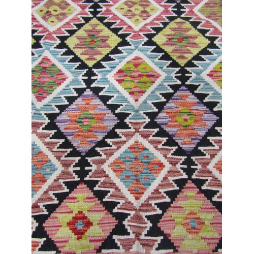 1565 - Chobi kilim,  with an all over geometric  stepped medallion pattern in pale hues, 183cm x 130cm