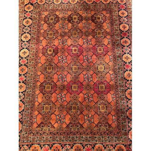 1546 - A Persian/Afghan rug with multi-medallion centre on ochre ground within alternating running borders,... 