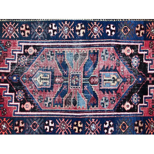 1550 - Vintage Persian rug with central tribal design and repeated pattern border, in tones of indigo, ceru... 