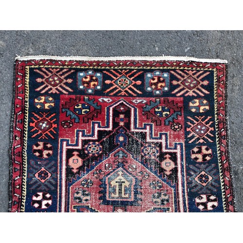 1550 - Vintage Persian rug with central tribal design and repeated pattern border, in tones of indigo, ceru... 