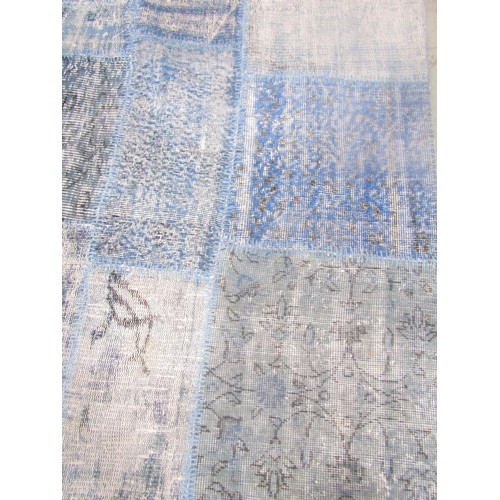 1557 - A Turkish patchwork patchwork carpet in patches of blues and turquoise, on a backing 239cm 170cm.