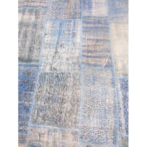 1557 - A Turkish patchwork patchwork carpet in patches of blues and turquoise, on a backing 239cm 170cm.