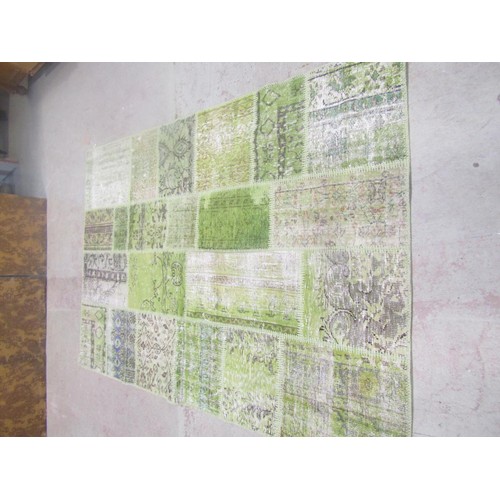 1562 - A Turkish patchwork carpet with patches in hues of green with abstract decoration, 243cm x 170cm.