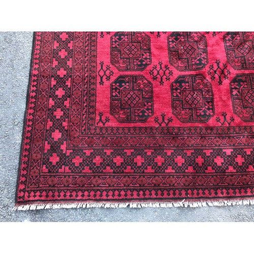 1592 - Large Afghan type rug with elephant foot design in deep red with black details, hand-knotted in wool... 