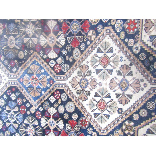 1581 - A Khameseh type carpet with three interlocking medallions 184cm x 150cm