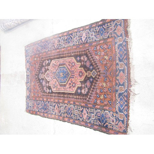 1579 - An antique Persian carpet with a shaped central medallion decorated with stylised flowers, with runn... 