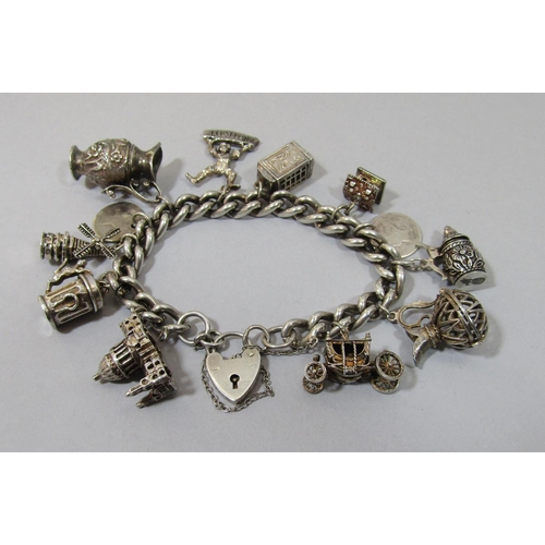 424 - Mixed lot of vintage silver jewellery to include two curb link novelty charm bracelets, a Siam niell... 