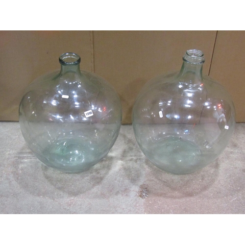 1096 - Two similar vintage light green tinted glass carboys, 55 cm high approximately