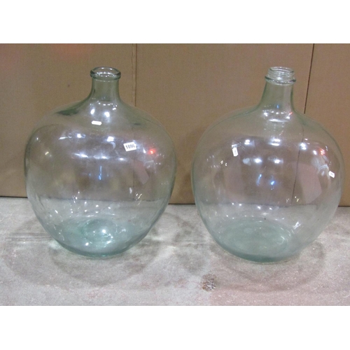 1096 - Two similar vintage light green tinted glass carboys, 55 cm high approximately