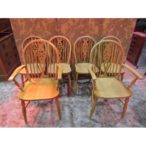 1110 - A set of six modern beech Windsor wheel back dining chairs (4&2)