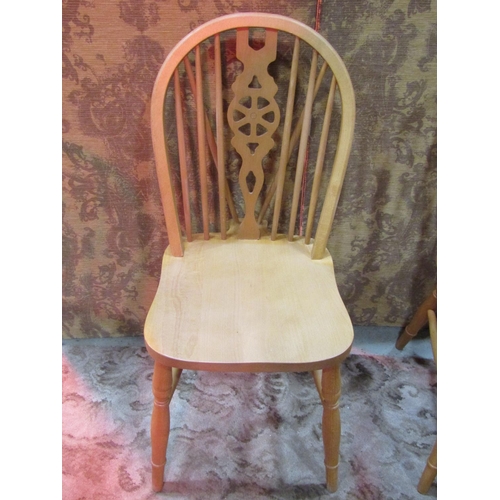 1110 - A set of six modern beech Windsor wheel back dining chairs (4&2)