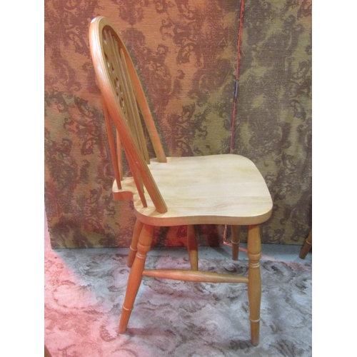 1110 - A set of six modern beech Windsor wheel back dining chairs (4&2)