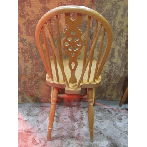 1110 - A set of six modern beech Windsor wheel back dining chairs (4&2)