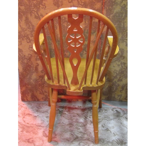 1110 - A set of six modern beech Windsor wheel back dining chairs (4&2)