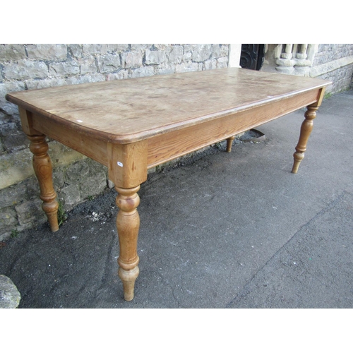 1155 - A stripped pine farmhouse kitchen table, the rectangular top with moulded outline and rounded corner... 