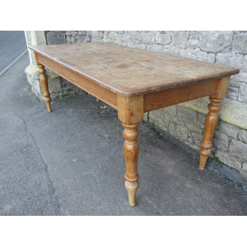 1155 - A stripped pine farmhouse kitchen table, the rectangular top with moulded outline and rounded corner... 