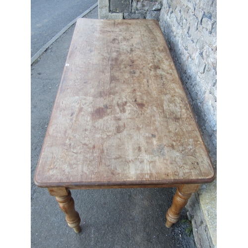 1155 - A stripped pine farmhouse kitchen table, the rectangular top with moulded outline and rounded corner... 