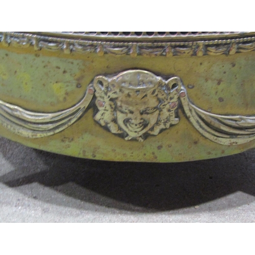 1165 - An oval brass planter with classical tied ribbon, swag and mask detail, removable liner and swept pa... 