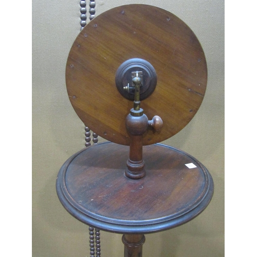 1166 - A Victorian walnut shaving stand with adjustable circular framed mirror, raised on a fluted colum an... 